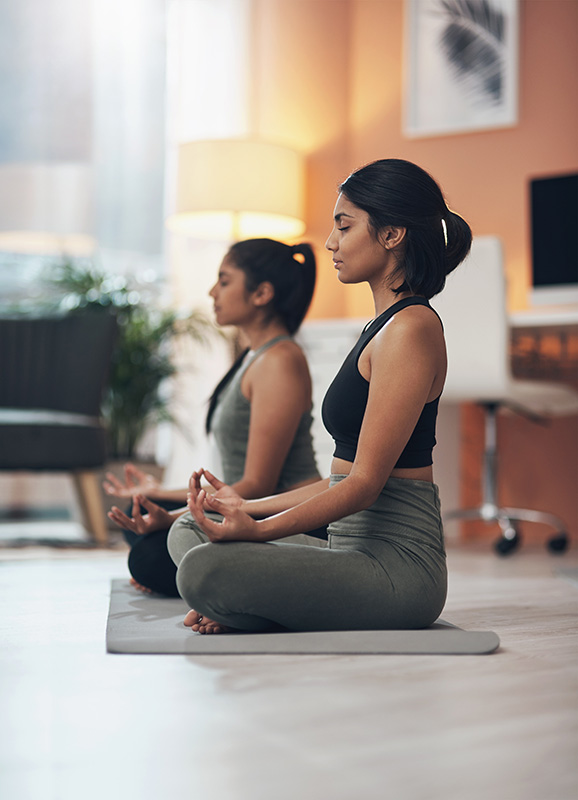 Two women practice mindfulness and meditation.