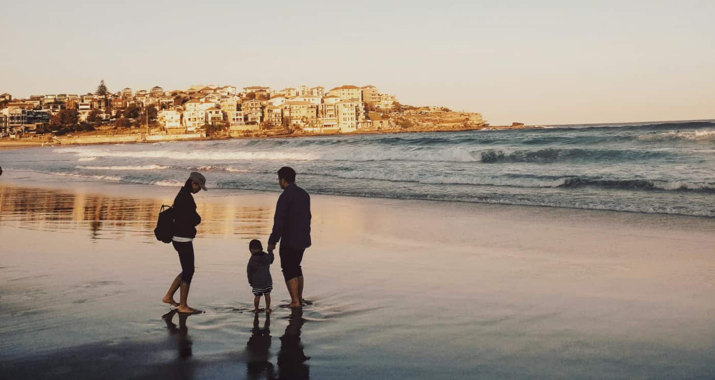 Family walks on the beach at sunset to show what is outpatient like: it is flexible for life.